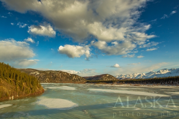 Looking down the Johnson River as it merges with the Tanana River, with the Alaska Range in the background.