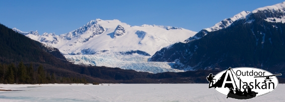 Mendehall Glacier flows into a frozen Mendehall Lake. Mount Wrather in the center and Mendehall Tower rise above the left ridge.