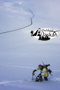 Haines local Jason Allgood stops for a minute while climbing Glave Peak to snowboard down it.