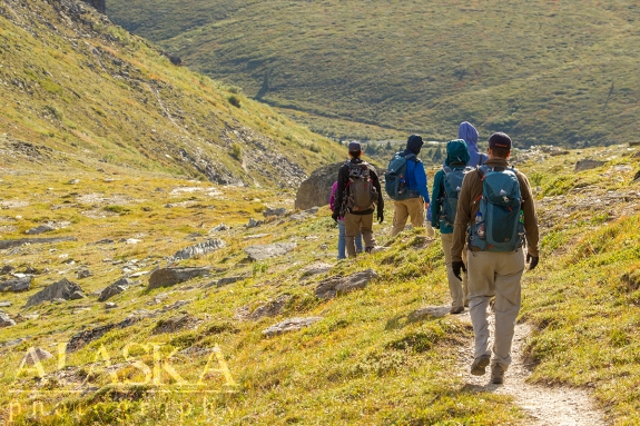 A group of hikers move along the trail.