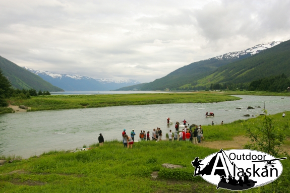 Rafters from the annual Mad Raft Race pull out of Chilkoot River before it enters Lutak Inlet in the distance.