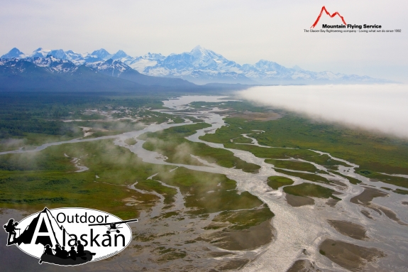A massive fog bank moves in from the Gulf of Alaska towards the East Alsek and Doame Rivers. Whilest Mount Fairweather looms above the other mountains of the Fairweather Range.