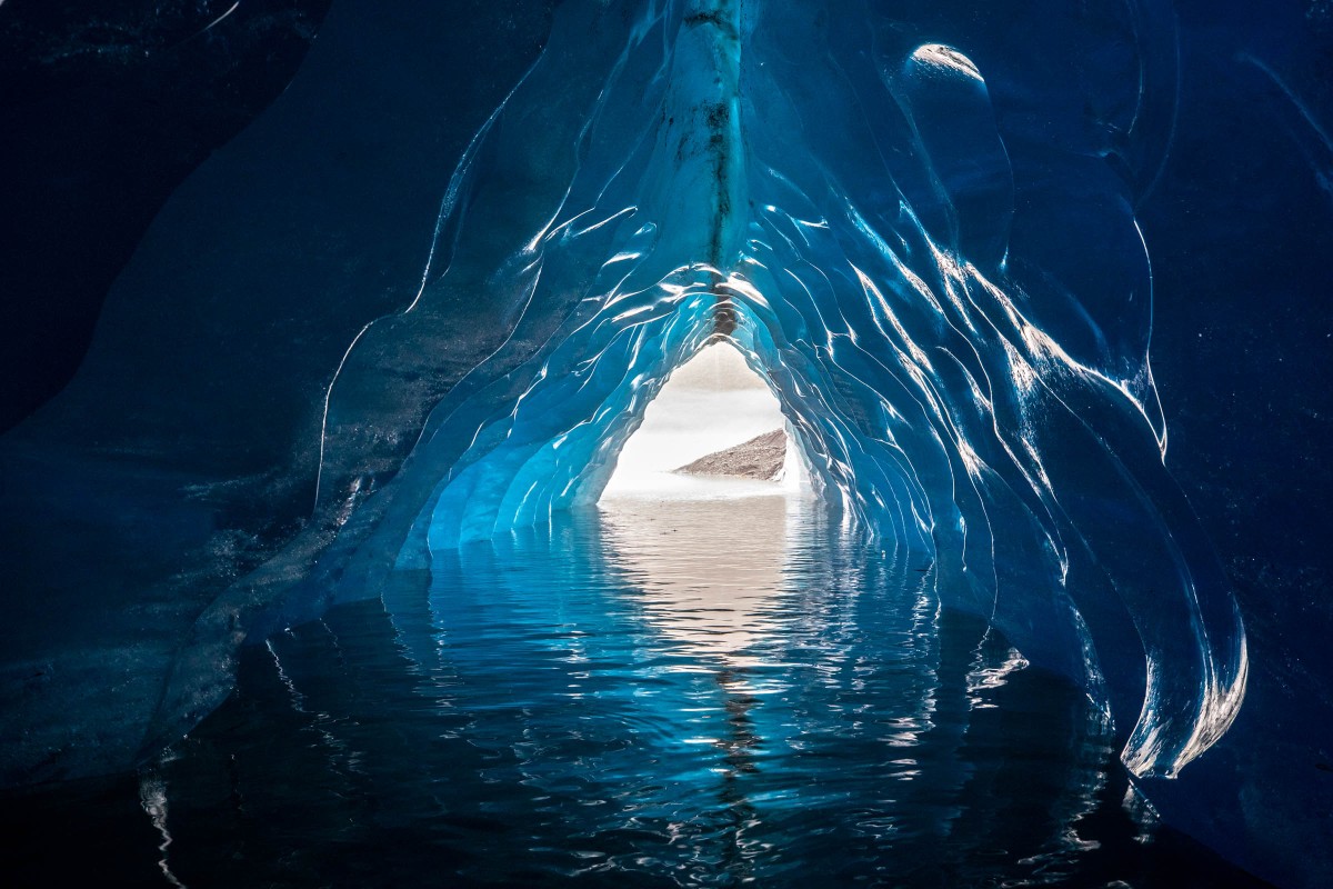 Looking out the front of an ice cave inside an iceberg. 2022