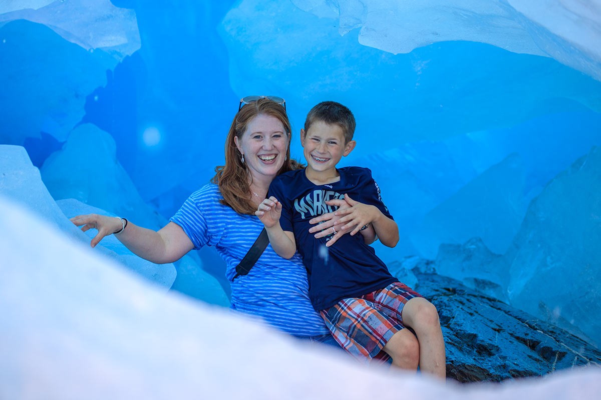 Mom and son enjoy climbing around inside Worthington Glacier on this adventure tour.