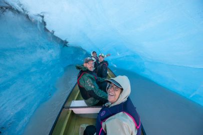 Inside a bright blue ice cave, likely the best tour in Valdez, Alaska.