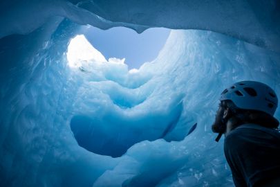 Ice climbing inside a moulin of a glacier near Valdez.