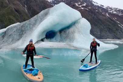 Checking out moulin tunnels in the icebergs on the SUPs.