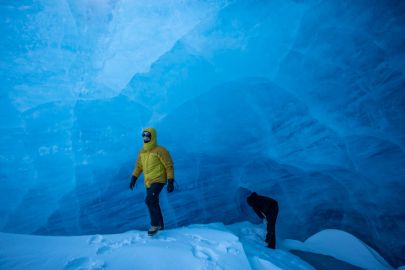 Walking underneath a wall of blue glacier ice.