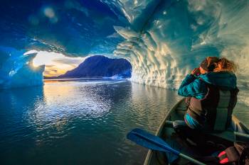 Watching the sunset from inside the cave of an iceberg.