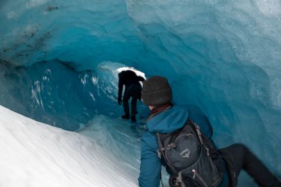 Climbing through a moulin tube.