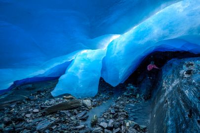 Kids climb around beneath Worthington Glacier.