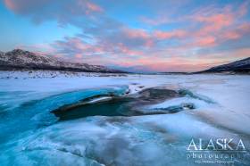 An opening in the ice of the Delta River on a cold morning in March.