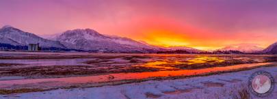 A vibrant winter sunset over Duck Flats, Valdez, Alaska.