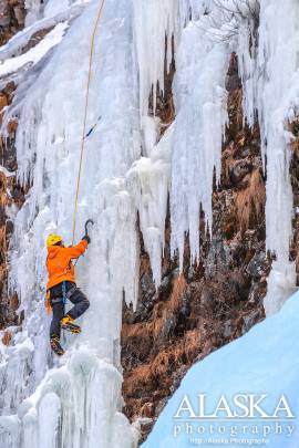 An ice climber climbs Flying Cloud in Keystone Canyon, Valdez.