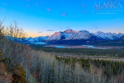 Matanuska Glacier (left) winds around Mount Wickersham (center).