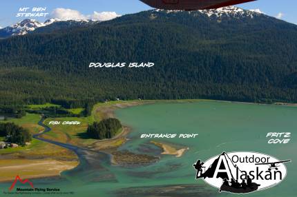 Fish Creek runs north off Douglas Island. The mouth of the creek has Entrance Point on the west shore and hut point on its east shore. Mount Ben Stewart is visible in the back.