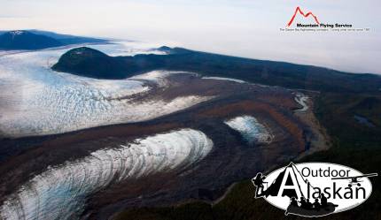 Looking across the front of La Perouse Glacier as it empties into a fog bank over the Gulf of Alaska. South Dome to the left and Middle Dome between the glacier. July 2009.