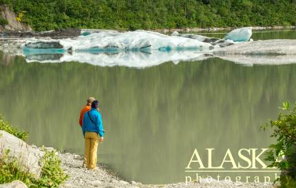 Tourist talk along the shore while looking out at the icebergs of Valdez Glacier.